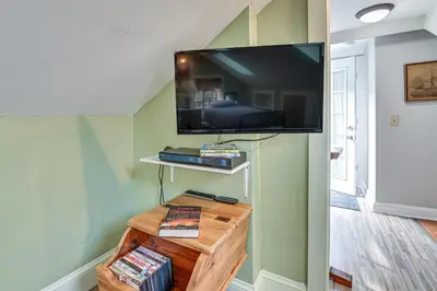 a living room with a flat screen tv on a wall at Quaint and Charming Cherry Valley Escape! in Cherry Valley