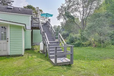 a staircase leading up to a house with an umbrella at Quaint and Charming Cherry Valley Escape! in Cherry Valley