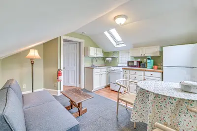 a kitchen and living room with a couch and a table at Quaint and Charming Cherry Valley Escape! in Cherry Valley