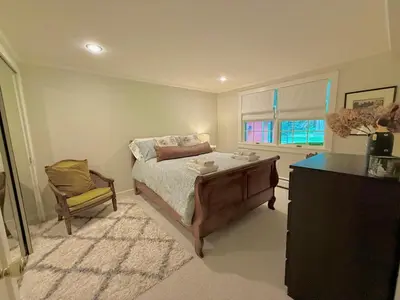a bedroom with a bed and a dresser and a window at Beautiful House in the Woods, Huge Yard, Hot Tub in Great Barrington