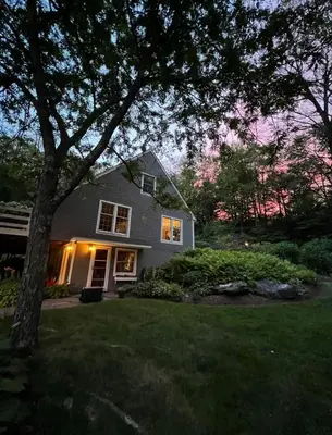 a house with a tree in the yard at Beautiful House in the Woods, Huge Yard, Hot Tub in Great Barrington