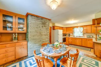 a kitchen with a table and chairs in a kitchen at Serene Duplex with On-Site Brook in Callicoon Center in Roscoe