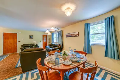 a living room with a table and chairs at Serene Duplex with On-Site Brook in Callicoon Center in Roscoe