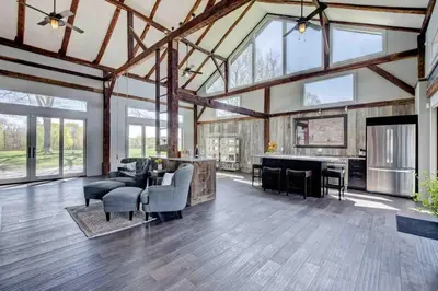a large living room with a large ceiling with windows at Longpond Farm House and Loft in Salisbury