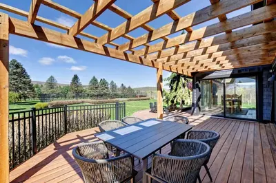 a wooden deck with a table and chairs at Longpond Farm House and Loft in Salisbury