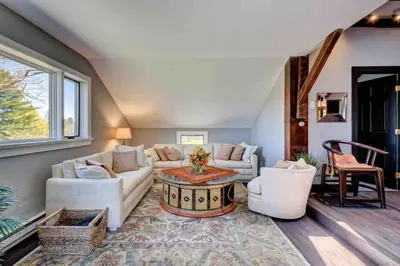 a living room with a couch and a table at Longpond Farm House and Loft in Salisbury