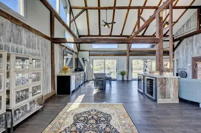 a large living room with wooden ceilings and wooden beams at Longpond Farm House and Loft in Salisbury