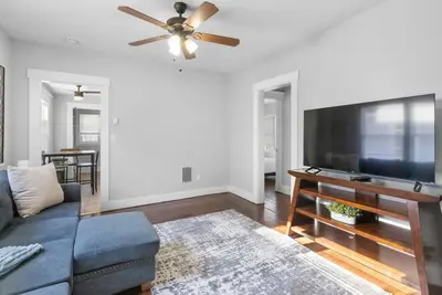 a living room with a couch and a flat screen tv at Quiet & Cozy Room by SCSU in New Haven