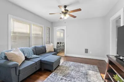 a living room with a couch and a ceiling fan at Quiet & Cozy Room by SCSU in New Haven