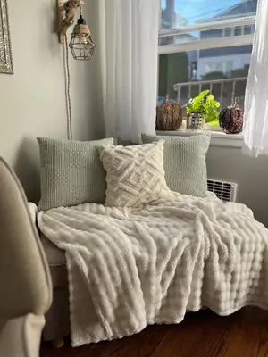 a bed with a white blanket and a window at Neighborhood Apt-walk to Train-McLean Ave, 30mins to NYC in Yonkers