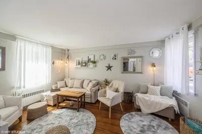 a living room with a couch and a table at Neighborhood Apt-walk to Train-McLean Ave, 30mins to NYC in Yonkers