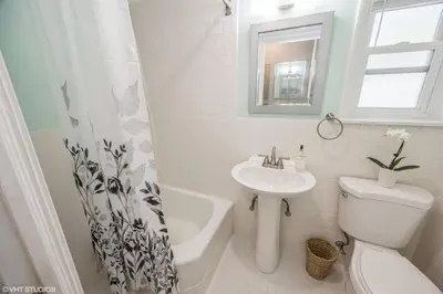 a bathroom with a sink and a toilet and a bath tub at Neighborhood Apt-walk to Train-McLean Ave, 30mins to NYC in Yonkers