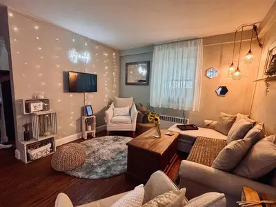 a living room with a couch and a tv at Neighborhood Apt-walk to Train-McLean Ave, 30mins to NYC in Yonkers
