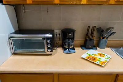 a kitchen counter with a toaster oven and a microwave at Hells Kitchen Hideaway in New York