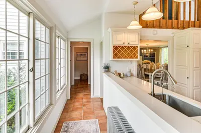 a kitchen with white cabinets and large windows at 1 Mi to Vineyard Serene Berkshires Country Escape in Richmond
