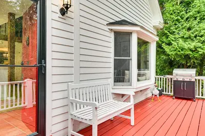 a white bench sitting on the front porch of a house at 1 Mi to Vineyard Serene Berkshires Country Escape in Richmond