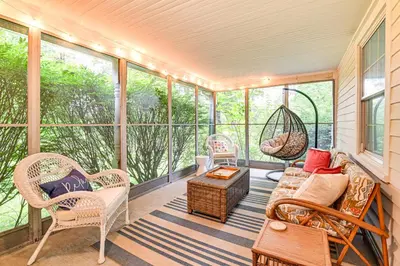 a screened in porch with wicker chairs and a swing at 1 Mi to Vineyard Serene Berkshires Country Escape in Richmond