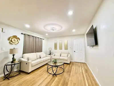 a living room with a couch and a table at Historic Barn View Modern Country Newton House in Newton
