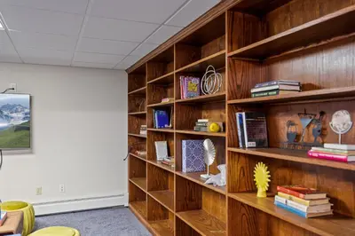 a library with wooden shelves with books at Huge Retreat w Alaska King, Pool & Jacuzzi Tub Indoor in Goshen