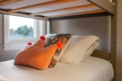a pair of feet on a bed with a pillow at Huge Retreat w Alaska King, Pool & Jacuzzi Tub Indoor in Goshen