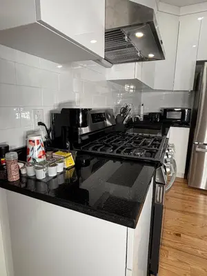 a kitchen with a stove and a counter top at 3 bedroom 1 bathroom apartment , free private parking in Schenectady