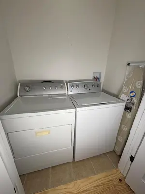 a kitchen with two stove and a washer and dryer at 3 bedroom 1 bathroom apartment , free private parking in Schenectady