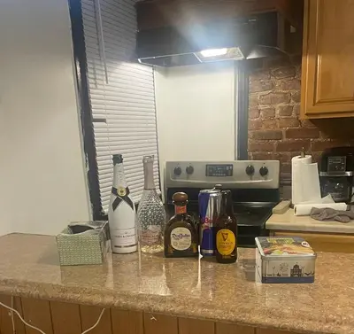 a kitchen counter with bottles of alcohol on it at Comodo y economico Apartamento in North Beach