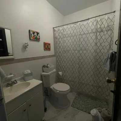 a bathroom with a shower and a toilet and a sink at Comodo y economico Apartamento in North Beach