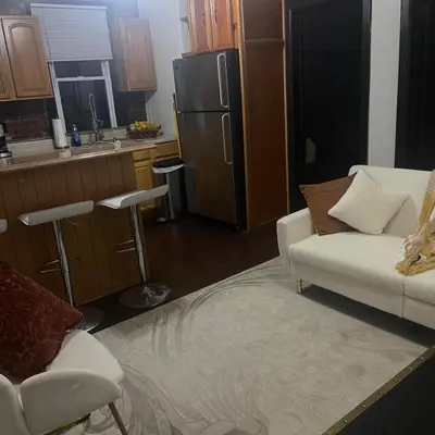 a kitchen with a refrigerator and a couch and a chair at Comodo y economico Apartamento in North Beach