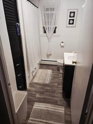 a bathroom with a sink and a toilet and a window at NEW 