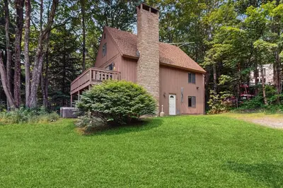 a house with a chimney on the side of it at Ski Haus Retreat in West Dover
