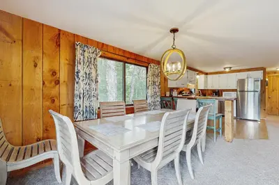 a dining room with a white table and chairs at Ski Haus Retreat in West Dover