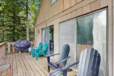a deck with chairs and a table on it at Ski Haus Retreat in West Dover