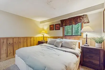 a bedroom with a white bed and a window at Ski Haus Retreat in West Dover