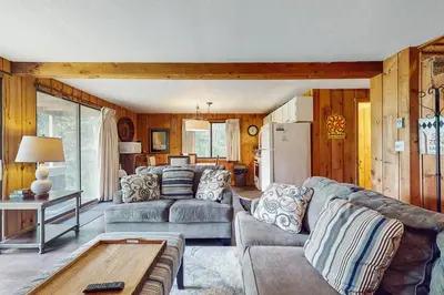 a living room with two couches and a table at Ski Haus Retreat - Unit A in Dover