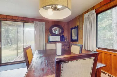 a dining room with a large wooden table and chairs at Ski Haus Retreat - Unit A in Dover
