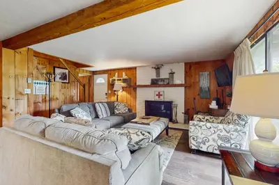 a living room with a couch and a fireplace at Ski Haus Retreat - Unit A in Dover