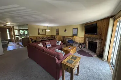 a living room with a couch and a fireplace at Snow Mountain Village 36D in Dover