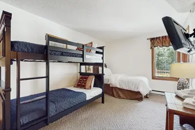 a bedroom with two bunk beds and a desk at Snow Mountain Village 36D in Dover