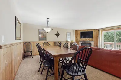 a dining room with a table and chairs and a couch at Snow Mountain Village 36D in Dover