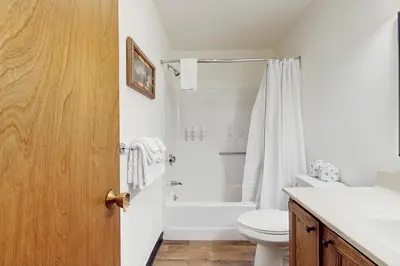 a white bathroom with a toilet and a shower at Snow Mountain Village 36D in Dover