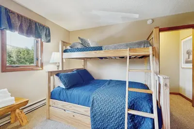 a bedroom with two bunk beds and a window at Snow Mountain Village 36D in Dover