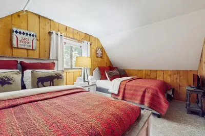 a bedroom with two beds and a window at Ski Haus Retreat - Unit B in Dover
