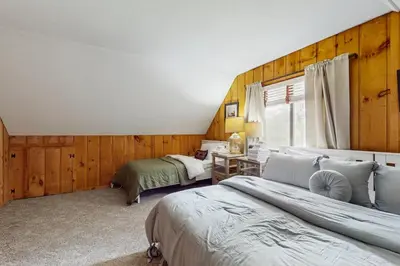 a bedroom with two beds and a desk at Ski Haus Retreat - Unit B in Dover
