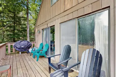 a deck with chairs and a table on it at Ski Haus Retreat - Unit B in Dover