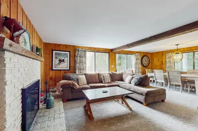 a living room with a couch and a fireplace at Ski Haus Retreat - Unit B in Dover