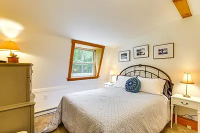 a bedroom with a bed and two lamps and a window at Ashokan Reservoir Treetop Suite in the Catskills in Olivebridge