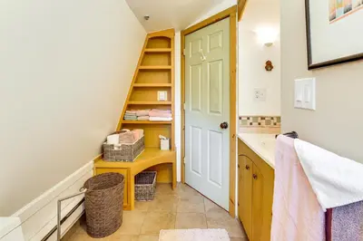 a bathroom with a staircase leading to a sink and a stairwayexit at Ashokan Reservoir Treetop Suite in the Catskills in Olivebridge
