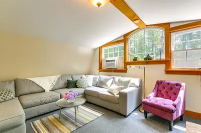 a living room with a couch and a chair at Ashokan Reservoir Treetop Suite in the Catskills in Olivebridge