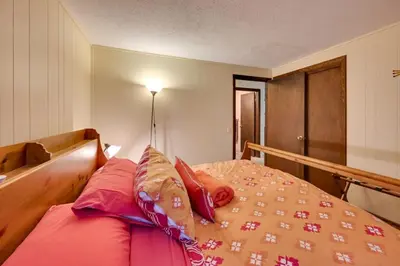 a bedroom with a bed with pillows on it at Tolland Lake Escape Kayaks Deck and Nature Trails in Sandisfield